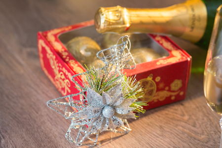 Glasses of champagne with gift box with Christmas ballsの写真素材