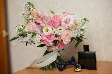 Bottle of male perfume, cufflinks and black bow tieの写真素材