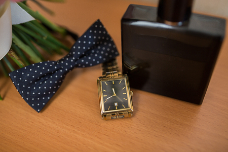 Bottle of male perfume, cufflinks and black bow tieの写真素材