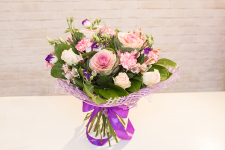 Beautiful flower bouquets on a light background of a brickの写真素材