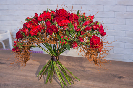 Beautiful flower bouquets on a light background of a brickの写真素材
