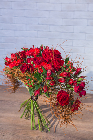 Beautiful flower bouquets on a light background of a brickの写真素材