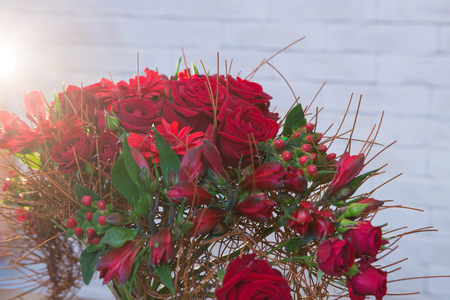 Beautiful flower bouquets on a light background of a brickの写真素材