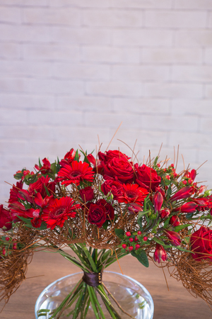 Beautiful flower bouquets on a light background of a brickの写真素材