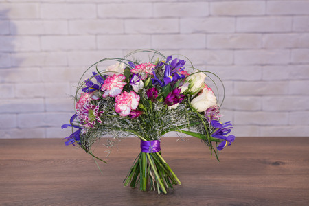 Beautiful flower bouquets on a light background of a brickの写真素材