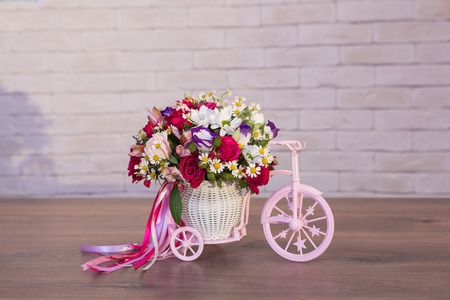 Beautiful flower bouquets on a light background of a brickの写真素材