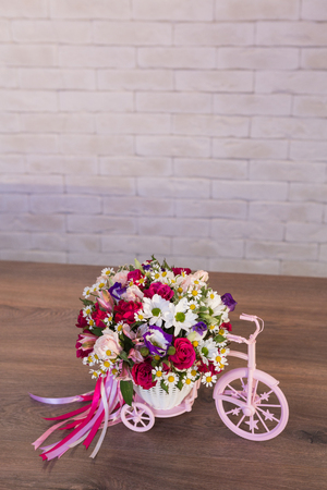 Beautiful flower bouquets on a light background of a brickの写真素材