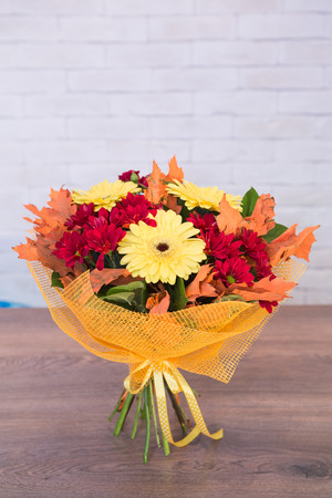 Beautiful flower bouquets on a light background of a brickの写真素材