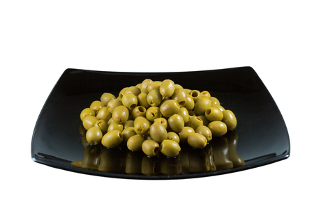 green olives isolated on white in black dishの写真素材