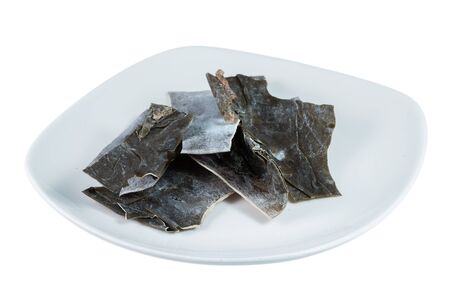 Kombu sea vegetable in bowl over white backgroundの写真素材