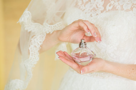 bride applying gentle perfume on her wrist