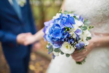 Beautiful wedding bouquet in hands of the brideの写真素材