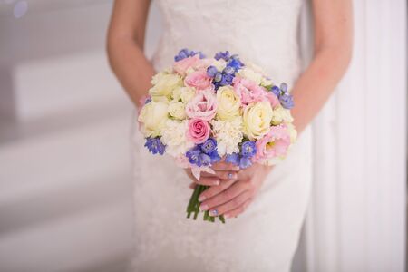 Beautiful wedding bouquet in hands of the brideの写真素材