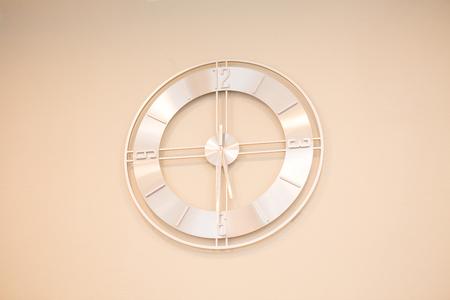 beige wall clock on a light backgroundの写真素材