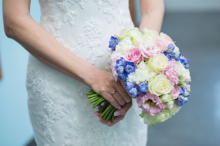 Beautiful wedding bouquet in hands of the brideの写真素材