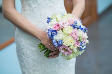 Beautiful wedding bouquet in hands of the brideの写真素材