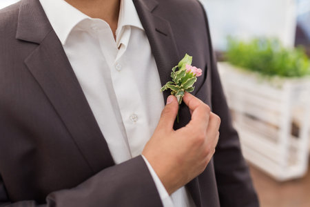 Boutonniere on hip trendy groom at weddingの写真素材