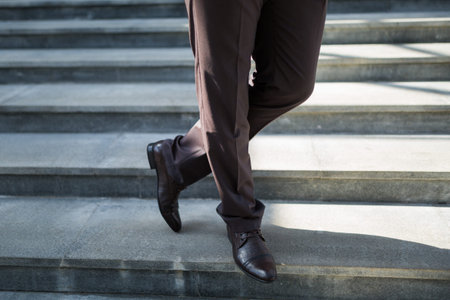Walking downstairs: close-up view of man's leather shoes