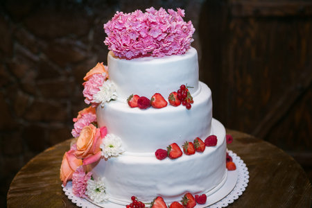 white multi level wedding cake with flower decorations