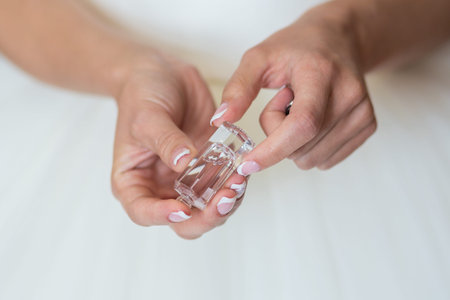 bride applying gentle perfume on her wristの写真素材