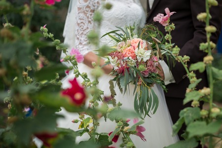 Beautiful wedding bouquet in hands of the brideの写真素材