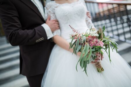Beautiful wedding bouquet in hands of the brideの写真素材
