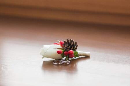 white roses groomsmen boutonniere and wooden backgroundの写真素材