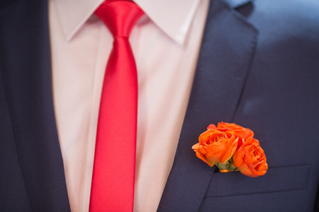 Boutonniere on hip trendy groom at weddingの写真素材