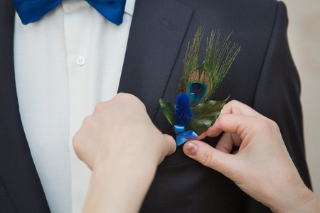 Boutonniere on hip trendy groom at weddingの写真素材