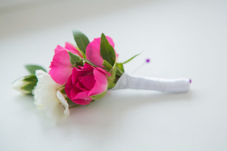 white roses groomsmen boutonniere and wooden backgroundの写真素材