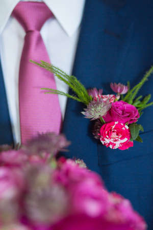Boutonniere on hip trendy groom at weddingの写真素材