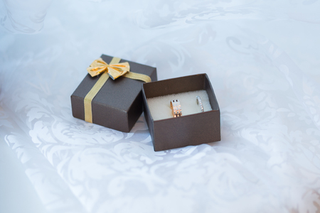 Close-up of a jewelry box with two elegant white gold rings, symbol of engagement and eleganceの写真素材