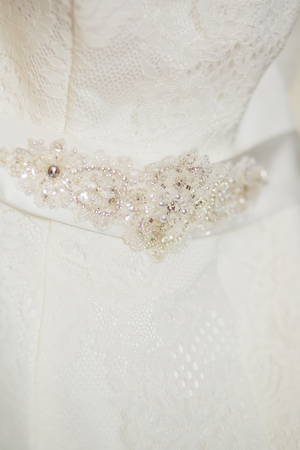A close up of a wedding dress with a large silk bowの写真素材