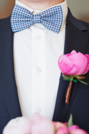 Boutonniere on hip trendy groom at weddingの写真素材