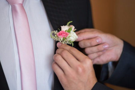 Boutonniere on hip trendy groom at wedding
