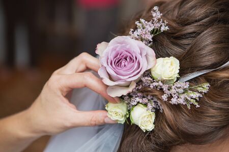 Wedding hairstyle of the bride, the beautiful decorations in the head. Wedding accessories. Female jewelry for girls. Details for marriage and for a married coupleの写真素材
