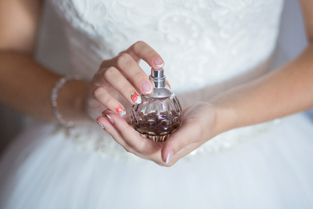 bride applying gentle perfume on her wristの写真素材