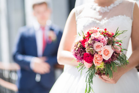 Beautiful wedding bouquet in hands of the brideの写真素材