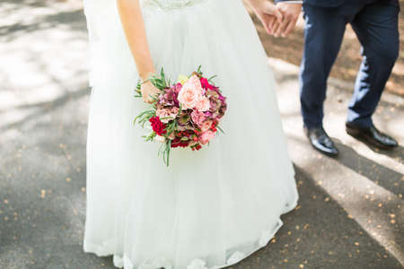 Beautiful wedding bouquet in hands of the brideの写真素材