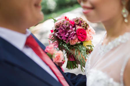 Beautiful wedding bouquet in hands of the brideの写真素材