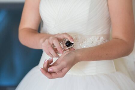 bride applying gentle perfume on her wristの写真素材