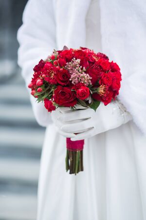 Beautiful wedding bouquet in hands of the brideの写真素材