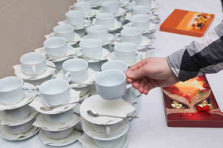 Many rows of coffee or tea cups for background. Men take a cup of teaの写真素材