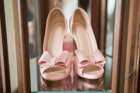 Stylish fashion pink high heels with a bow on the background room, glamor, bridal, weddingの写真素材