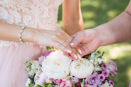 mother and daughter holding hands on her wedding dayの写真素材
