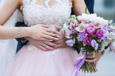 Beautiful wedding colorful bouquet with different flowers in the hands of the bride. Bridal summer bouquetの写真素材