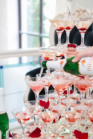 Pyramid of glasses for champagne or vine at the wedding party.の写真素材