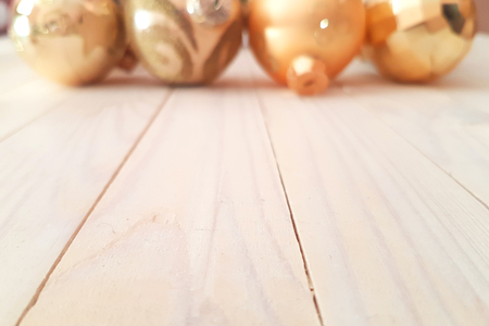 Christmas holiday background with white vintage wooden deck table over festive christmas gold balls. New Year conceptの写真素材