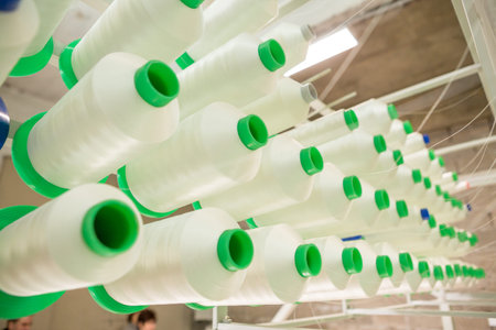Spun yarns in industrial sewing machine. Factory on manufacture of threads for Industrial Embroidery...