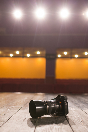 The camera on the wooden floor on scene with lamps and spotlightsの写真素材